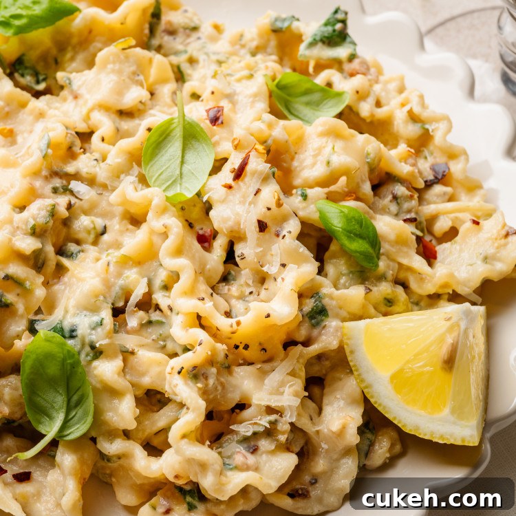 Zucchini lemon pasta garnished with basil and lemon