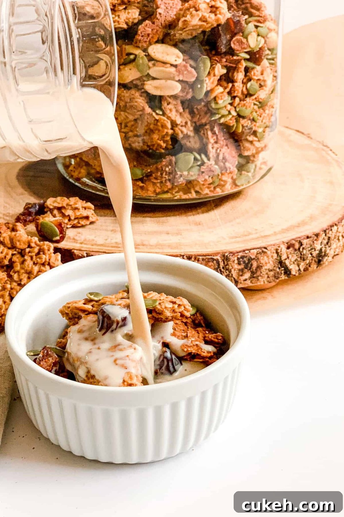 Pouring Milk into a Bowl of Healthy Crunchy Homemade Granola for Breakfast, Food Photography for Food Blog