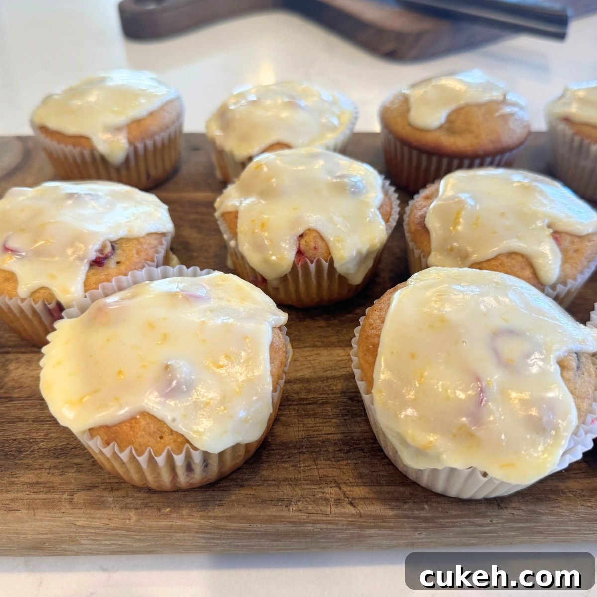 Glazed Cranberry Orange Muffins on cutting board