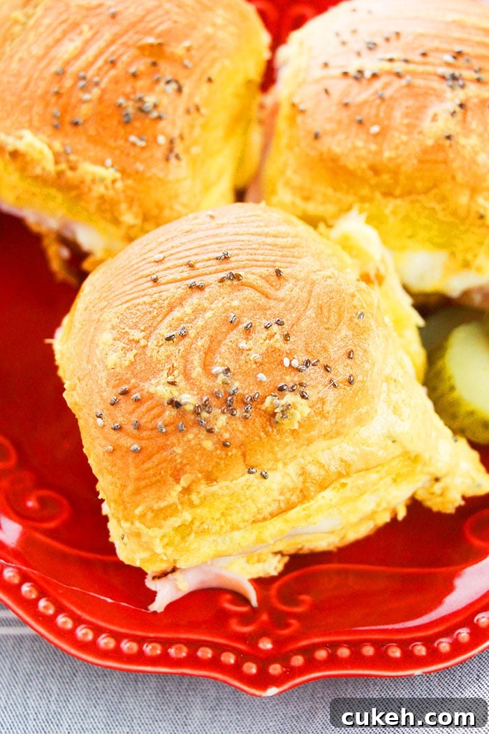 One-Pan Ham and Cheese Sliders Recipe for Quick Weeknight Meals 3 Ham Sliders on Red Plate
