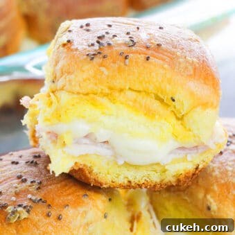 One-Pan Ham and Cheese Sliders Recipe for Quick Weeknight Meals 6 Easy Ham and Cheese Sliders Stacked on One Another in a Plate