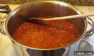 Add the grated tomatoes to the beef for moschari-me-agkinares