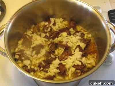 Add onions to the browned beef for moschari-me-agkinares