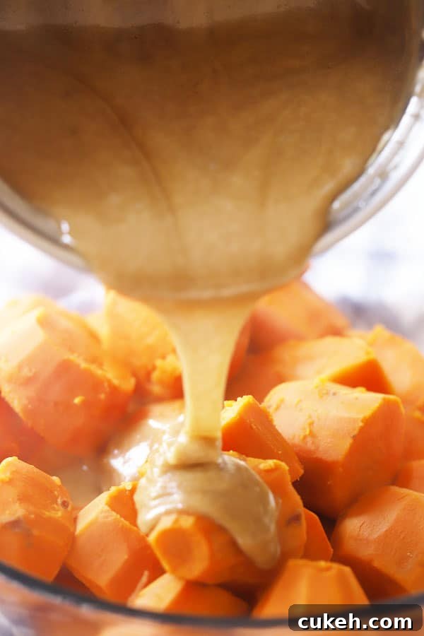 Pouring the brown sugar caramel mixture over cooked sweet potatoes.
