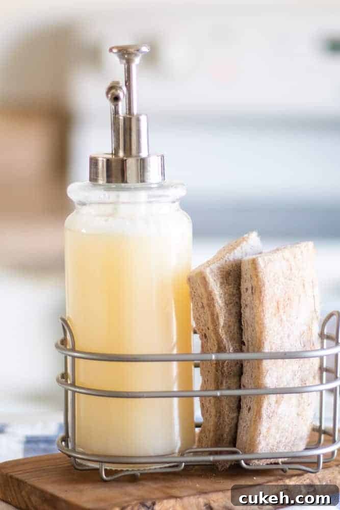 DIY Liquid Dish Soap Recipe: Affordable, Eco-Friendly Cleaner 4 gel homemade dish soap in silver caddy with tan sponges