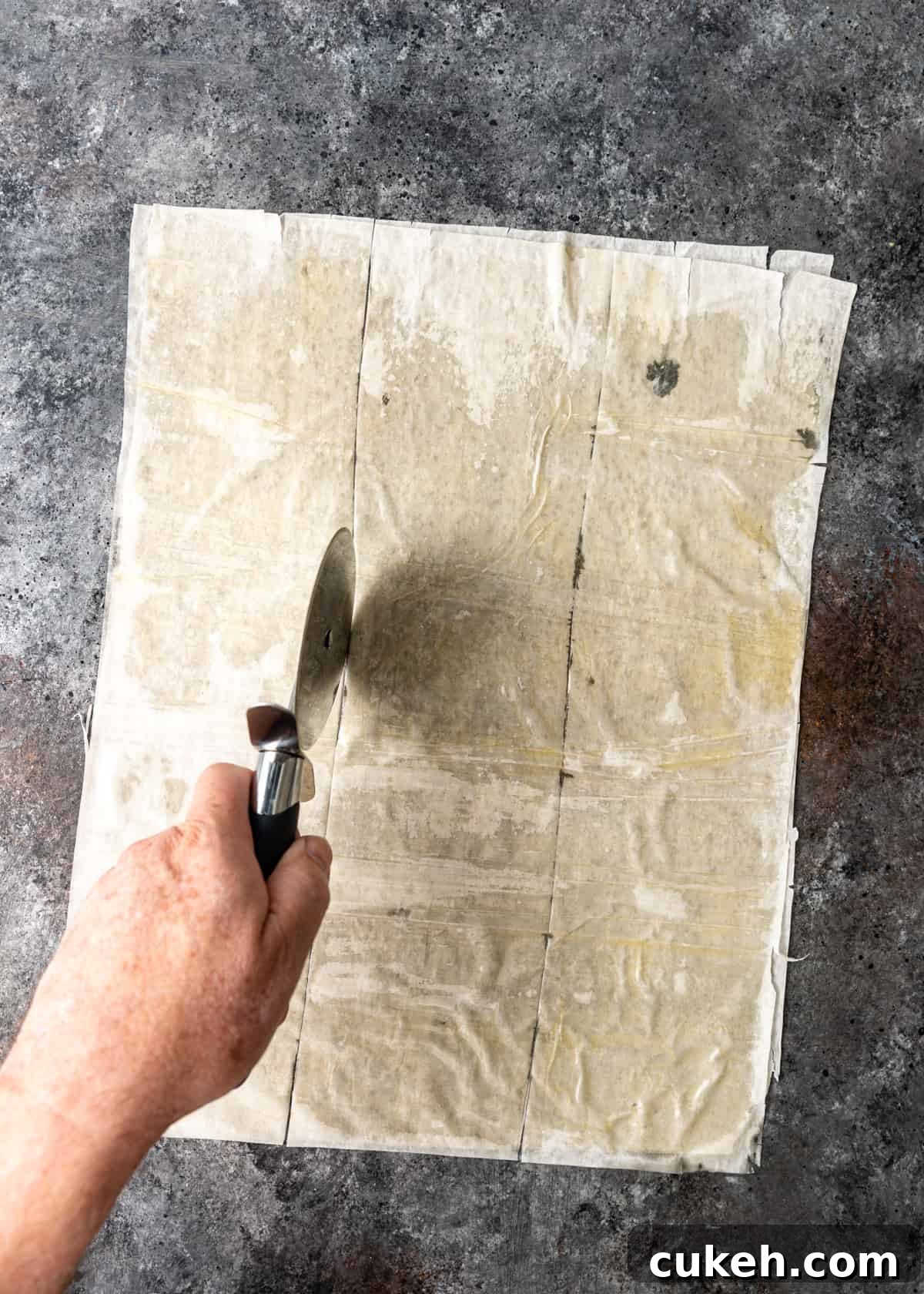 cutting buttered filo sheets