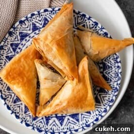 greek spinach pie phyllo appetizers on blue and white plate