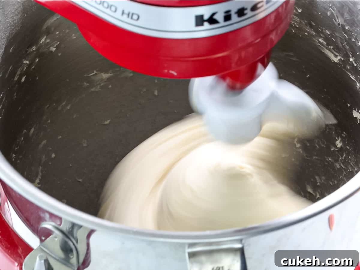 Dough being mixed in a stand mixer until it forms a ball.