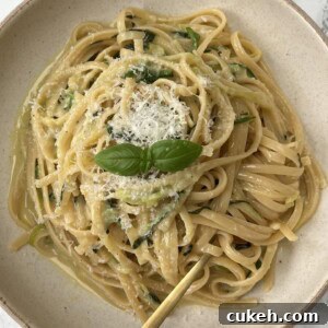 Lemon Courgette Pasta in a beige bowl with a fork in the pasta