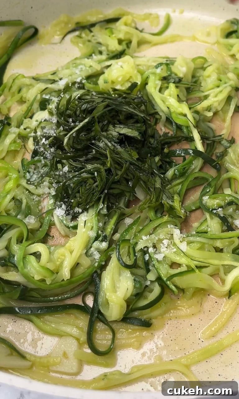 adding basil to courgette carbonara.